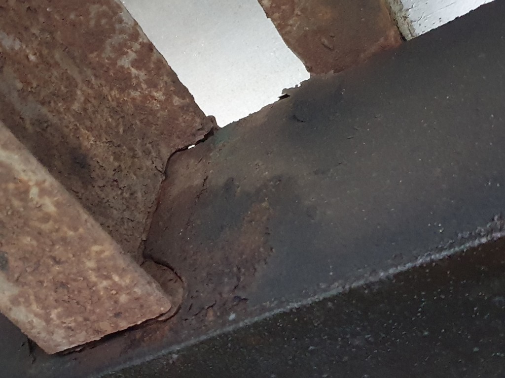 Pęknięcie i zaawansowana korozja elementu nośnego ramy pojazdu od spodu.